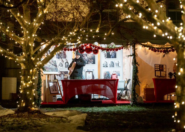 Vendors in the market enjoy the festive decorations that are part of the experience.